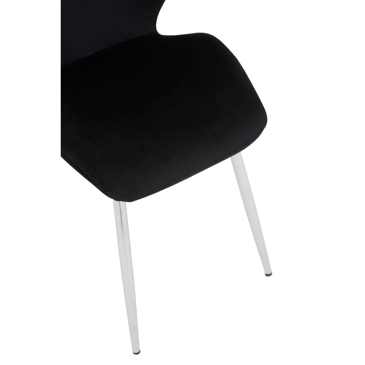 Black dining chair with a smooth, curved seat and sleek metal legs, partially visible in the image. The chair features a modern design, complementing a contemporary dining setup