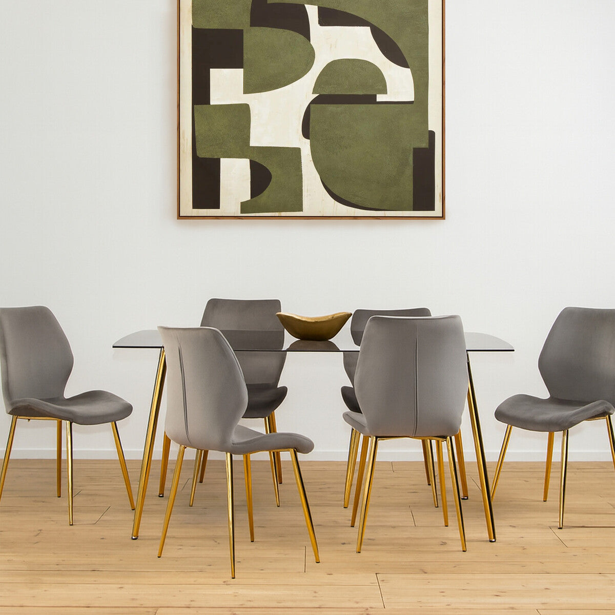 Smoked glass dining table surrounded by six modern gray chairs with wooden legs, set on a light wooden floor. A large abstract artwork in earthy tones hangs on the wall behind the table