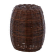 A cylindrical stool made from natural croco rattan, featuring a woven texture in rich brown tones, with an open design that allows light to pass through. The top is slightly rounded, and the overall shape is smooth and tapered towards the base