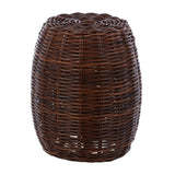 A cylindrical stool made from natural croco rattan, featuring a woven texture in rich brown tones, with an open design that allows light to pass through. The top is slightly rounded, and the overall shape is smooth and tapered towards the base