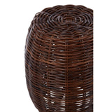 A round stool made from natural rattan, featuring a textured, woven design in dark brown tones. The top has a smooth, rounded edge, and the overall shape is slightly tapered towards the bottom