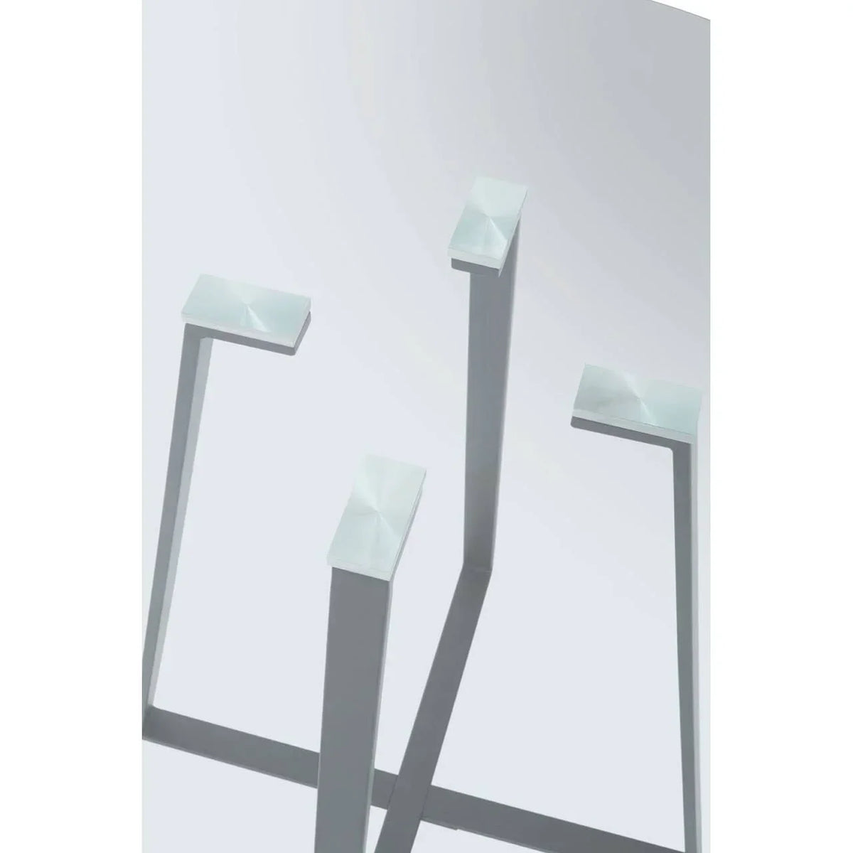 Brushed metal square dining table legs with cross frame, close up view