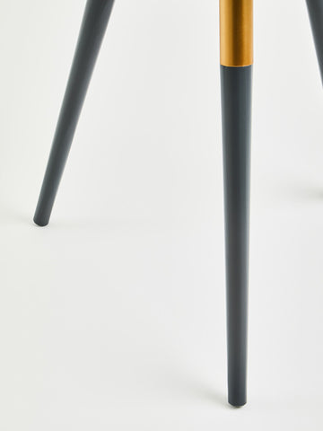 Dark grey side table leg with a tapered design, featuring a smooth finish and a contrasting golden accent near the base. The table leg is set against a light-colored background, emphasizing its modern aesthetic