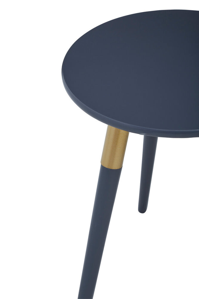 Round dark grey side table with a smooth surface and three tapered legs, one of which features a contrasting natural wood accent