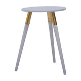 Round light grey side table with three tapered legs, two of which are light grey and one is natural wood, showcasing a modern and minimalist design