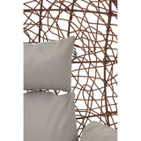 Brown rattan hanging chair featuring a woven design with a textured backrest and two light-colored cushions for comfort. The chair is suspended, showcasing its unique structure and natural materials
