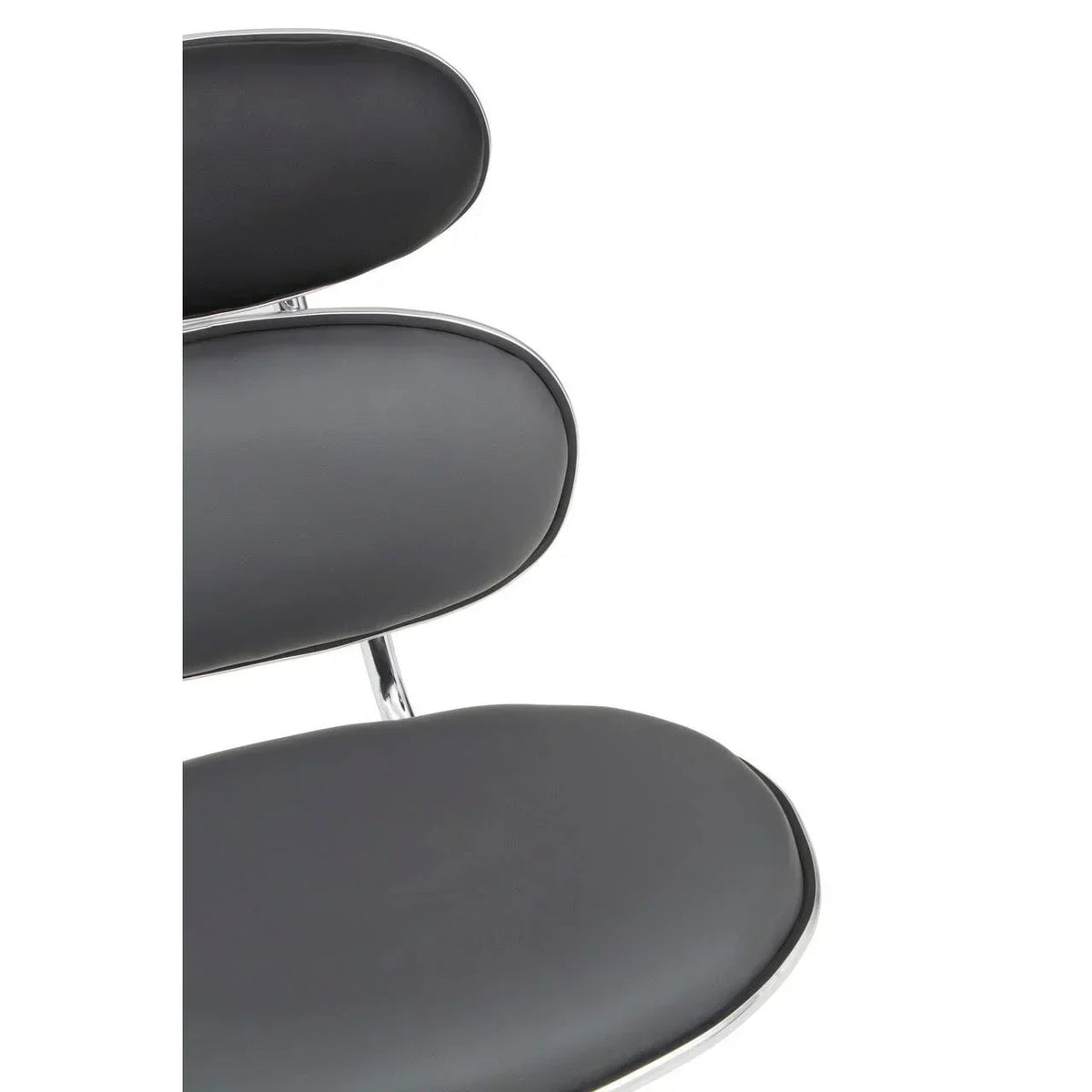 Closeup of black faux leather dining chair seat and backrest with chrome frame