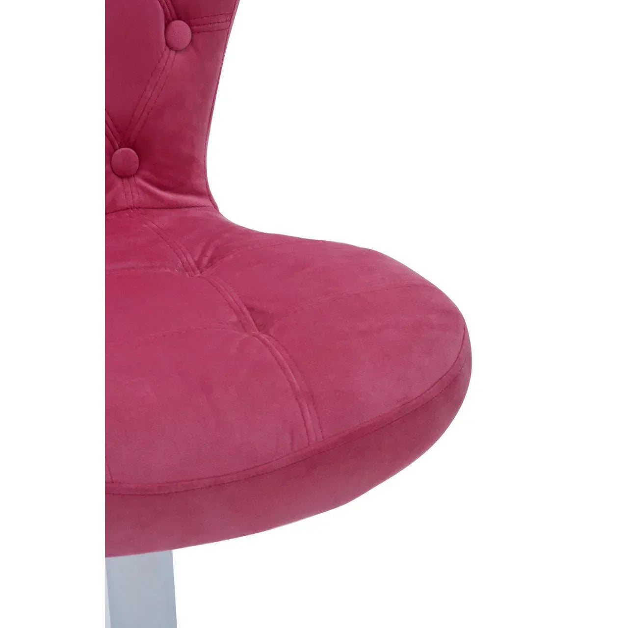 Closeup of pink velvet dining chair with button-tufted upholstery and padded seat