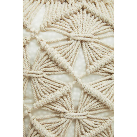 A close-up view of a West Village knitted pouffe featuring a textured design with intricate patterns made from natural-colored yarn, showcasing a geometric motif with diamond shapes and woven details