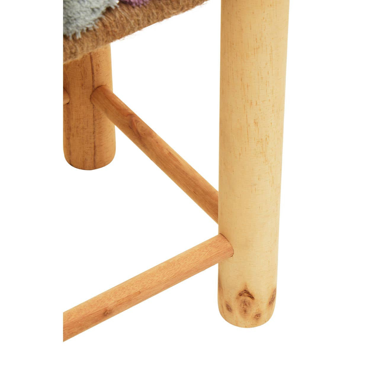 A close-up view of a wooden stool featuring light-colored legs and a woven seat adorned with grey, beige, and pink pom poms. The stool has a simple design with a sturdy frame and a crossbar for added support