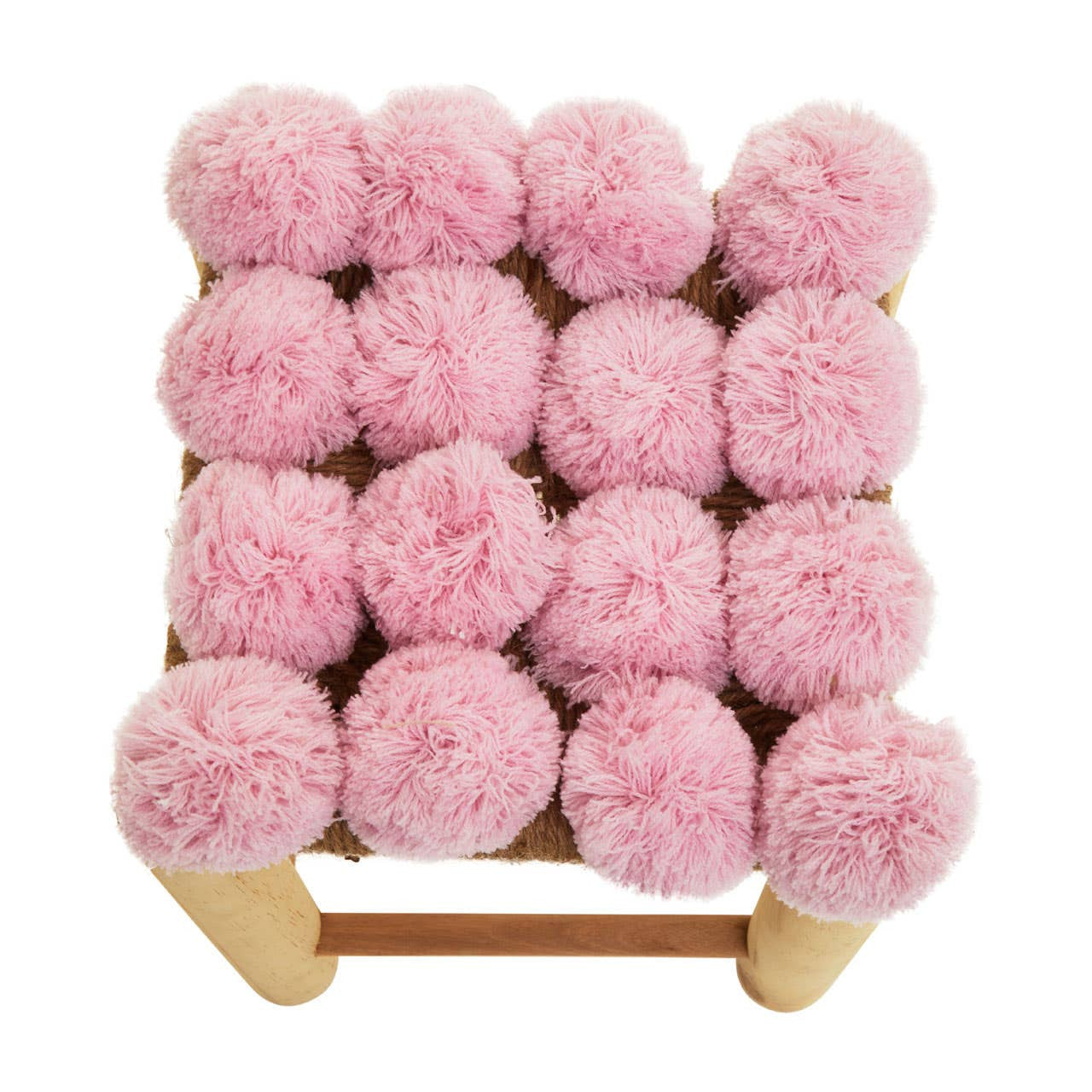 A square stool featuring a soft pink pom pom top with a grid pattern of fluffy pom poms, supported by a light wooden frame