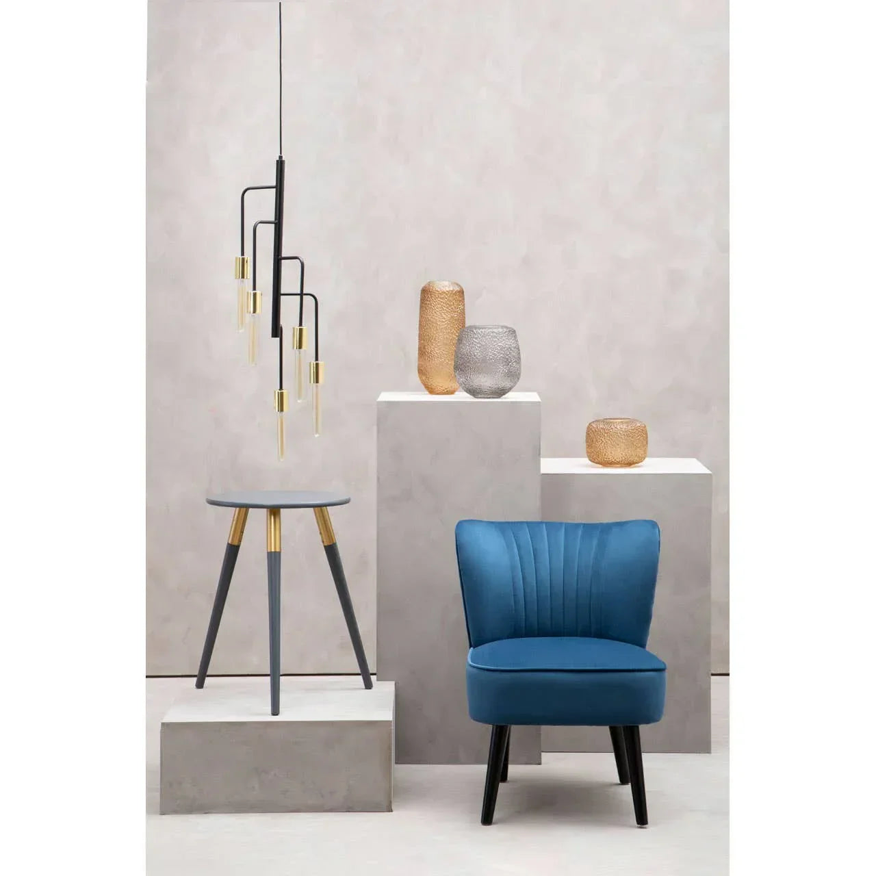 Blue accent chair with black legs beside modern grey side table and contemporary decor