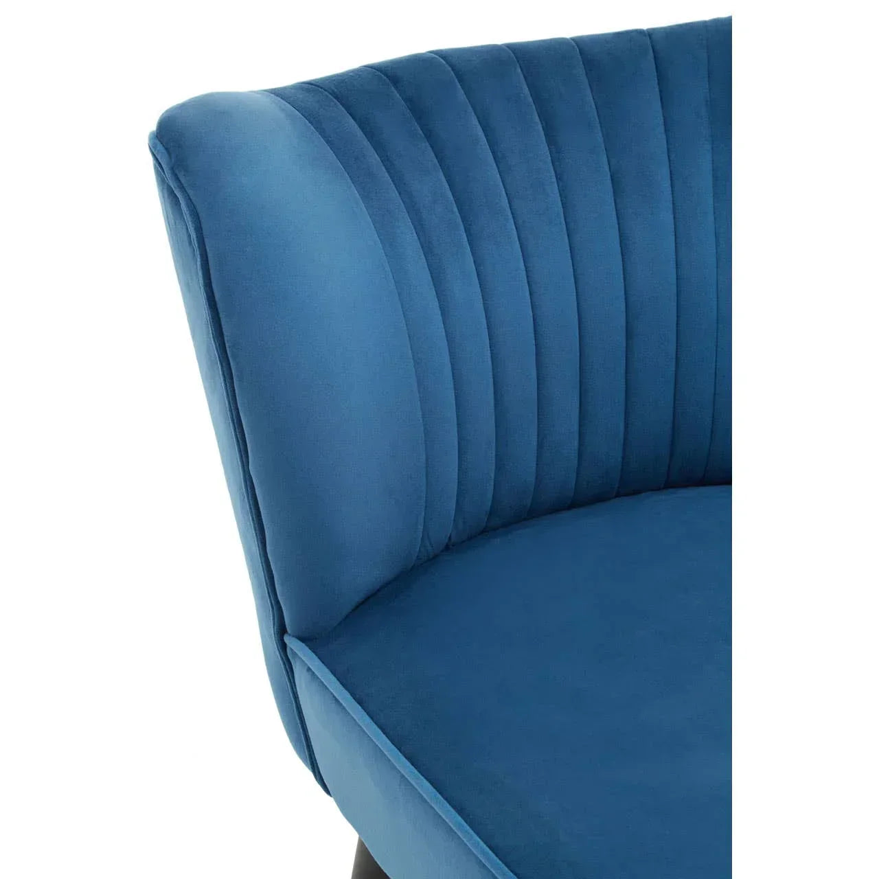 Blue velvet accent chair with channel stitched curved backrest close-up