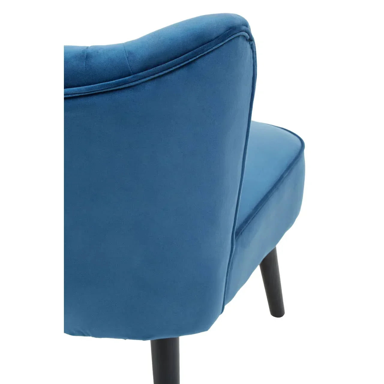 Blue velvet accent chair closeup with black wooden legs, side view