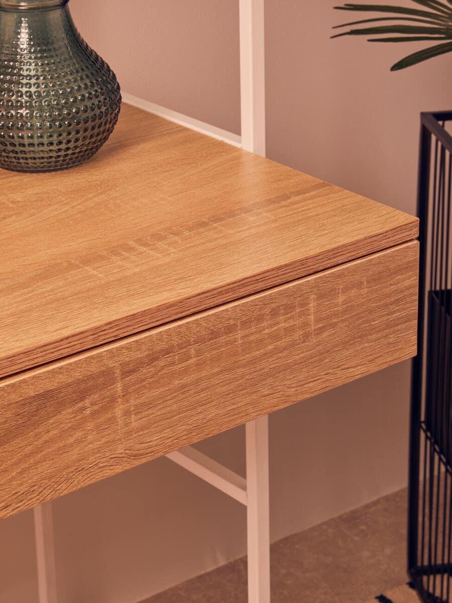 Oak-effect desk with white metal legs and single drawer, styled with a textured vase
