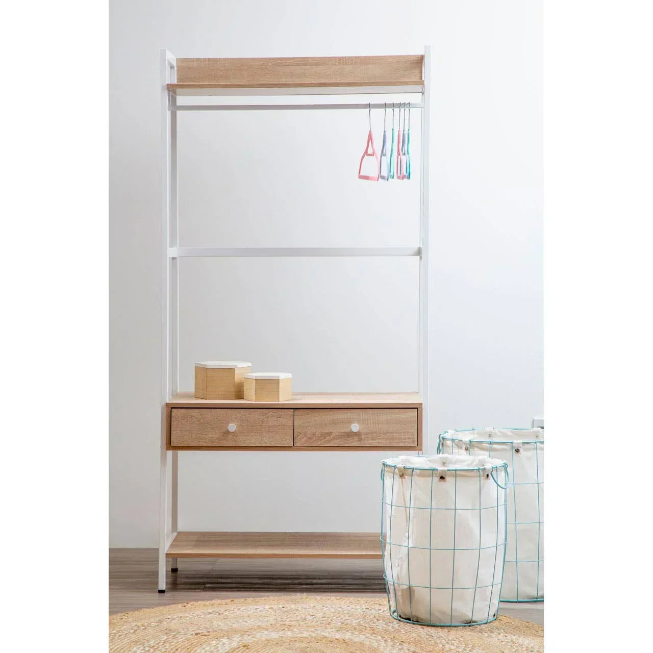Hallway storage unit with two drawers, hanging rail and baskets on wooden floor