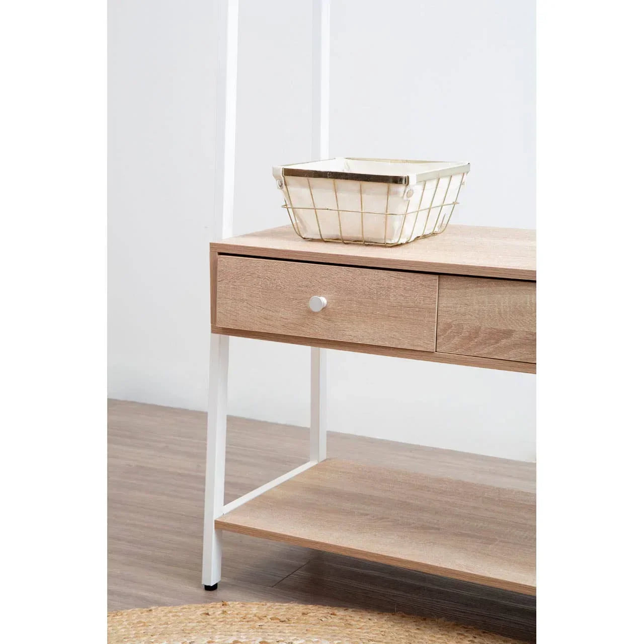 Light wood side table with single drawer, white metal legs, and wire storage basket on top
