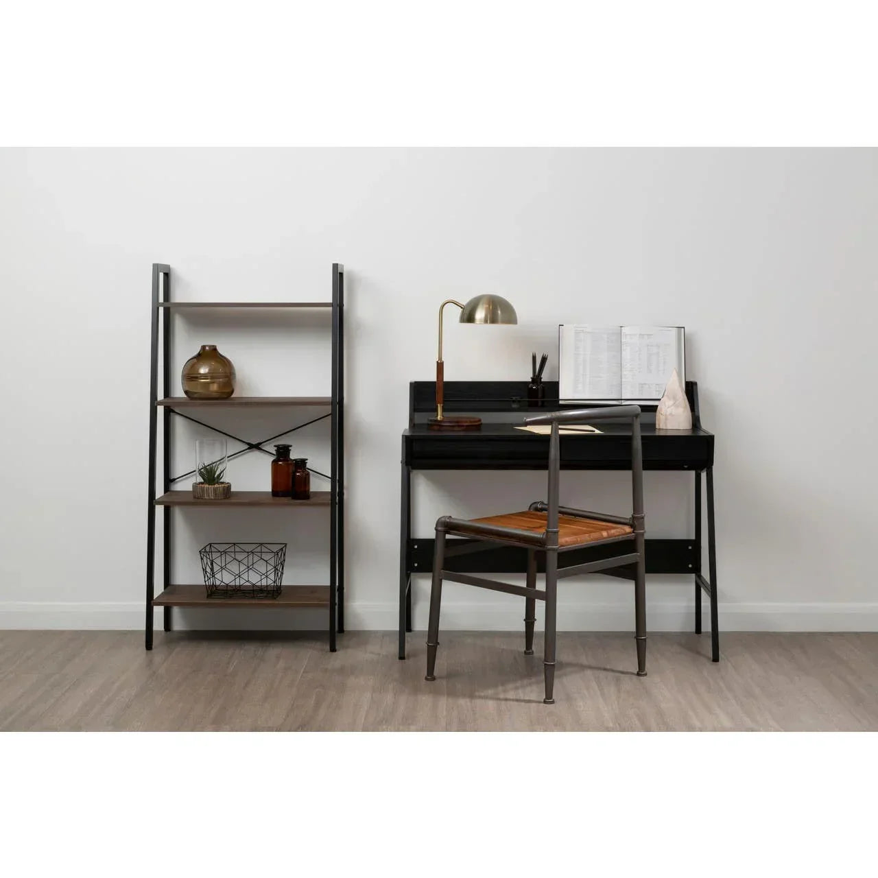 Black metal frame desk with wooden chair and shelving unit in modern home office setup