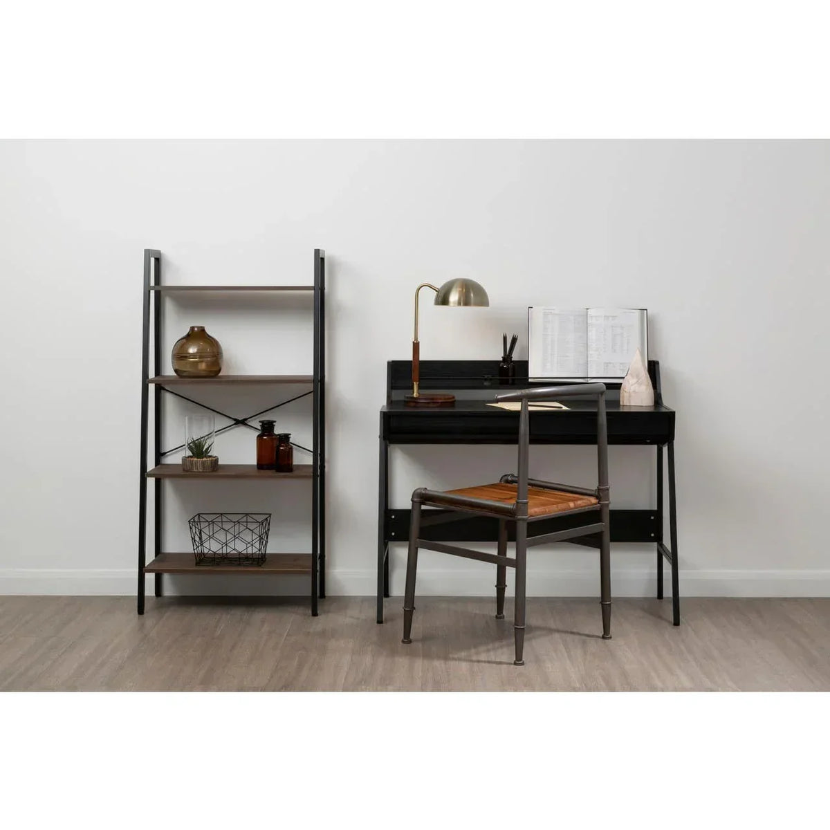 Black metal frame desk with wooden chair and shelving unit in modern home office setup