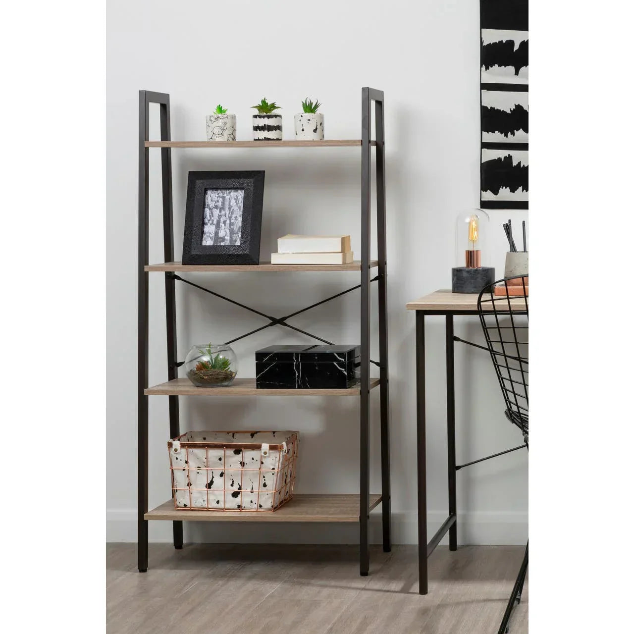 Industrial bookcase with black steel frame and wood shelves, styled with plants and decor