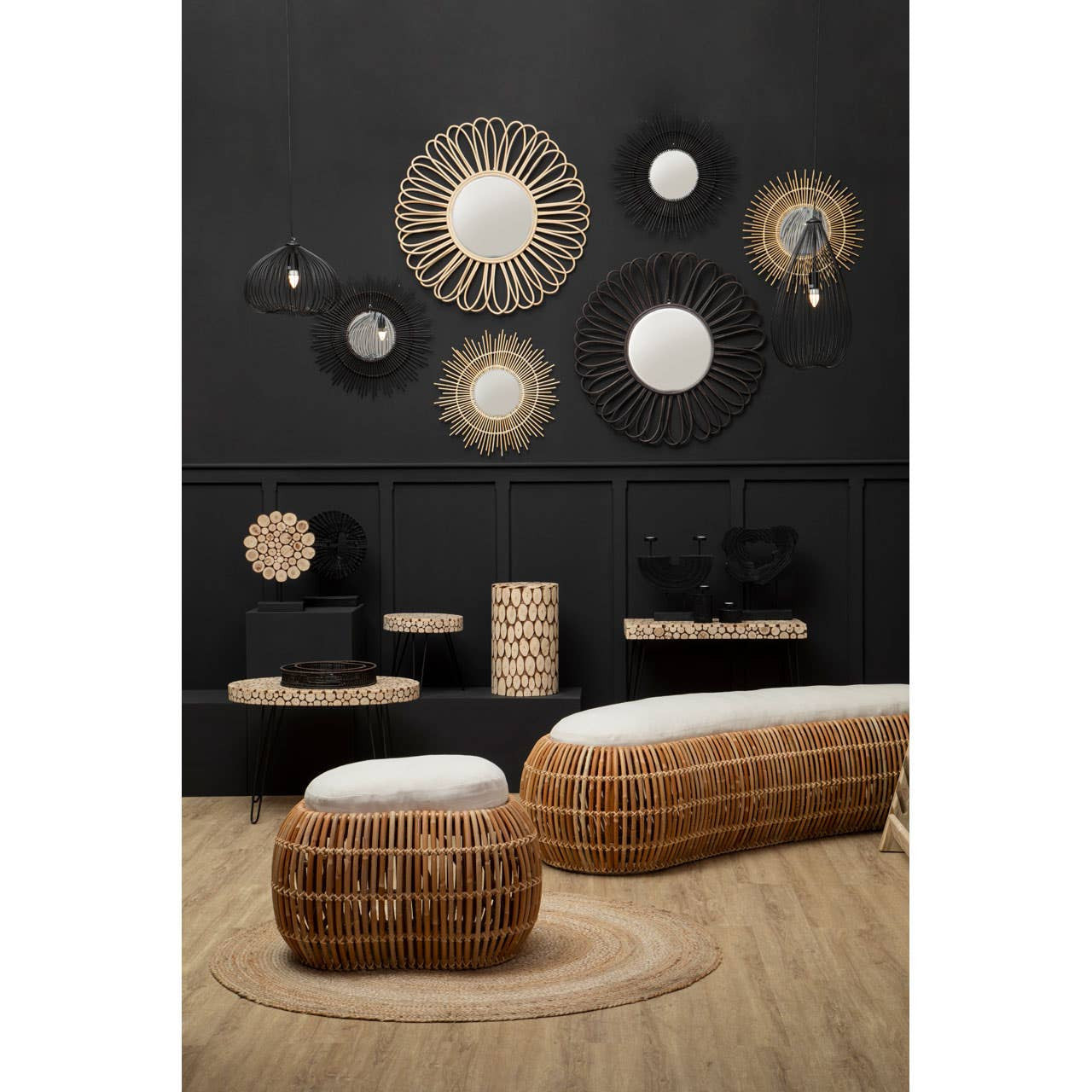 Round side table made of fir wood with a mosaic disc design, featuring a natural wood finish. The table is placed in a modern setting with a dark wall, surrounded by various decorative wall hangings and a woven bench. The floor is made of light wood, enhancing the warm tones of the furniture