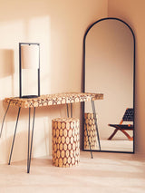 Lacuna Fir Wood Mosaic Disc Side Table and Stool featuring a circular mosaic design in natural wood tones, positioned next to a tall, arched mirror and a minimalist black chair against a soft beige wall. The table has a sturdy, textured surface and complements the overall warm aesthetic of the room