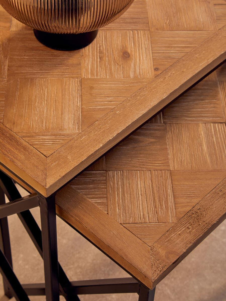 Wooden nesting tables with black metal legs and parquet tabletop detail