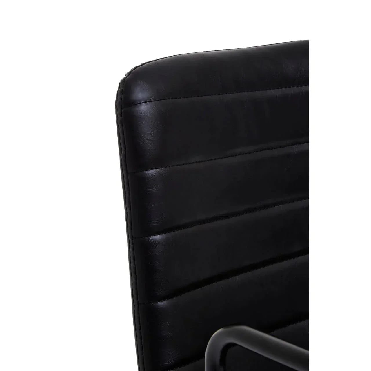 Close up of black leather chair backrest with horizontal stitch detail and metal armrest