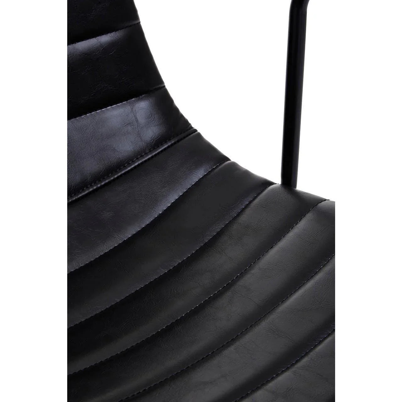 Close-up of black faux leather dining chair with vertical stitched seat detail