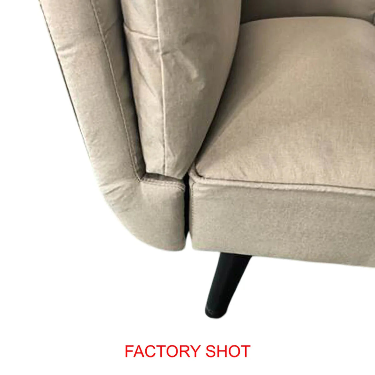 Close-up of beige fabric sofa armrest and cushion with black wooden leg