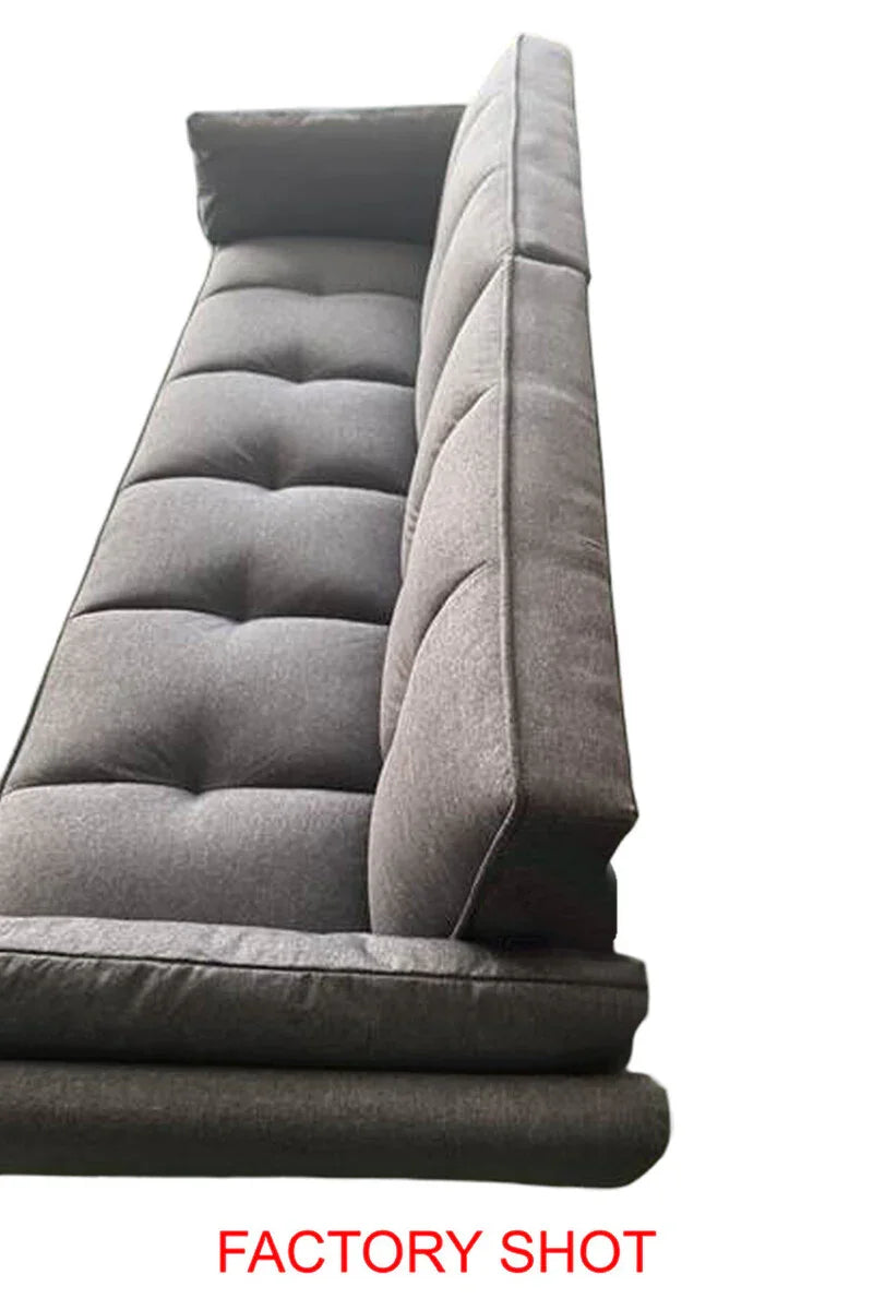 Side view of grey tufted sofa seat and back cushions on white background