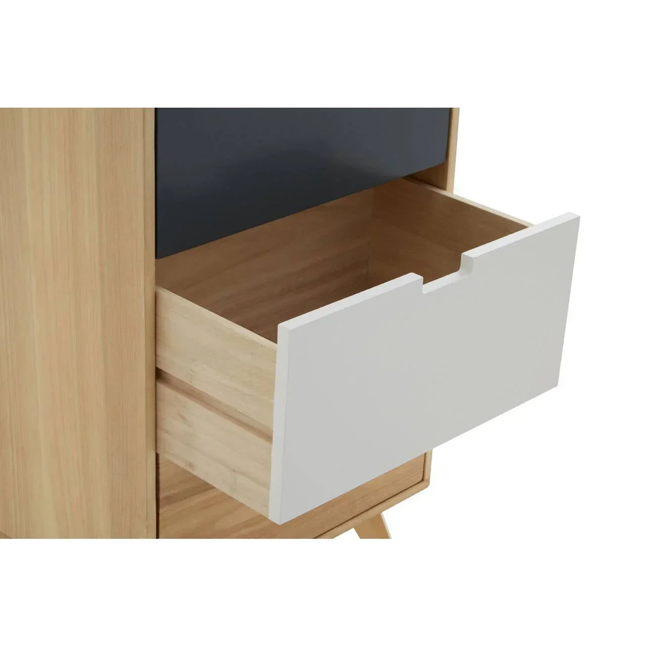 Light wood chest of drawers with open white drawer and cut-out handle detail