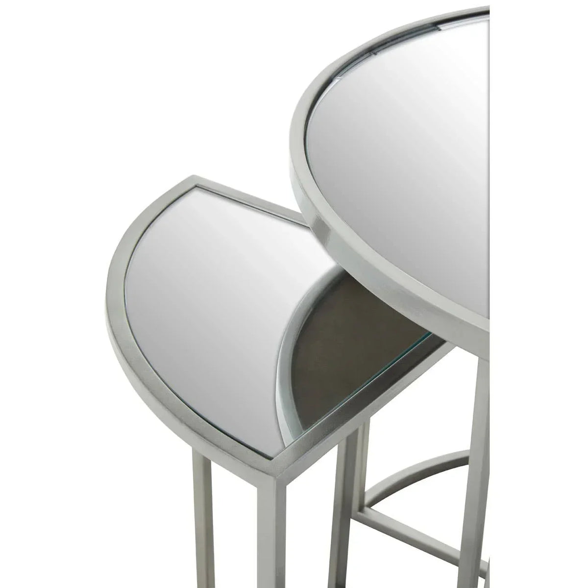Pair of round mirrored nesting tables with silver metal frames, close-up angle