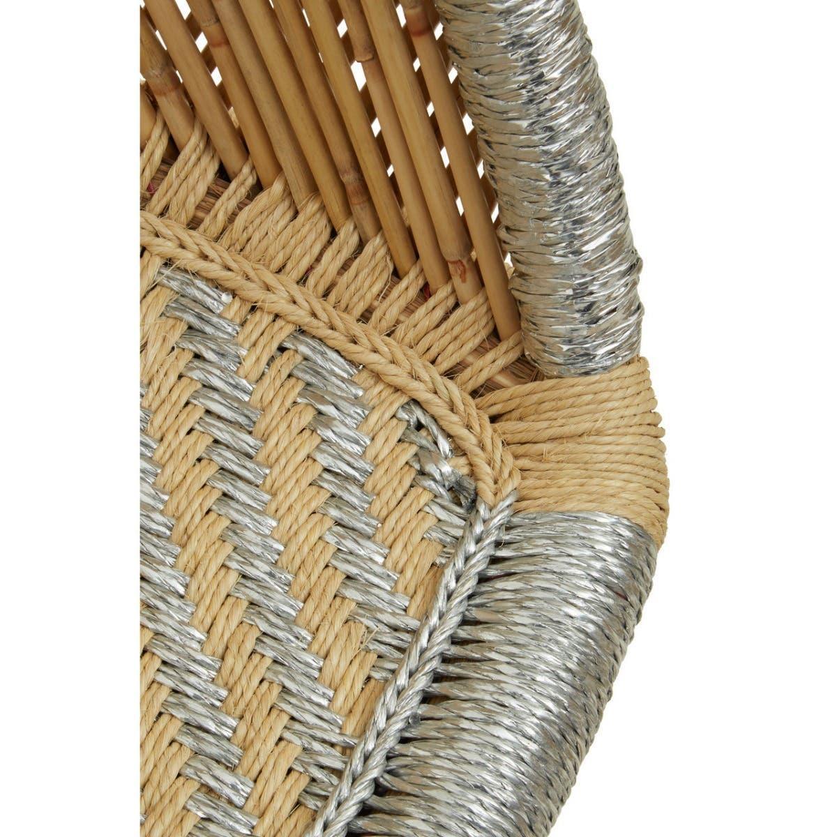 Closeup of woven rattan chair with silver and natural rope detailing