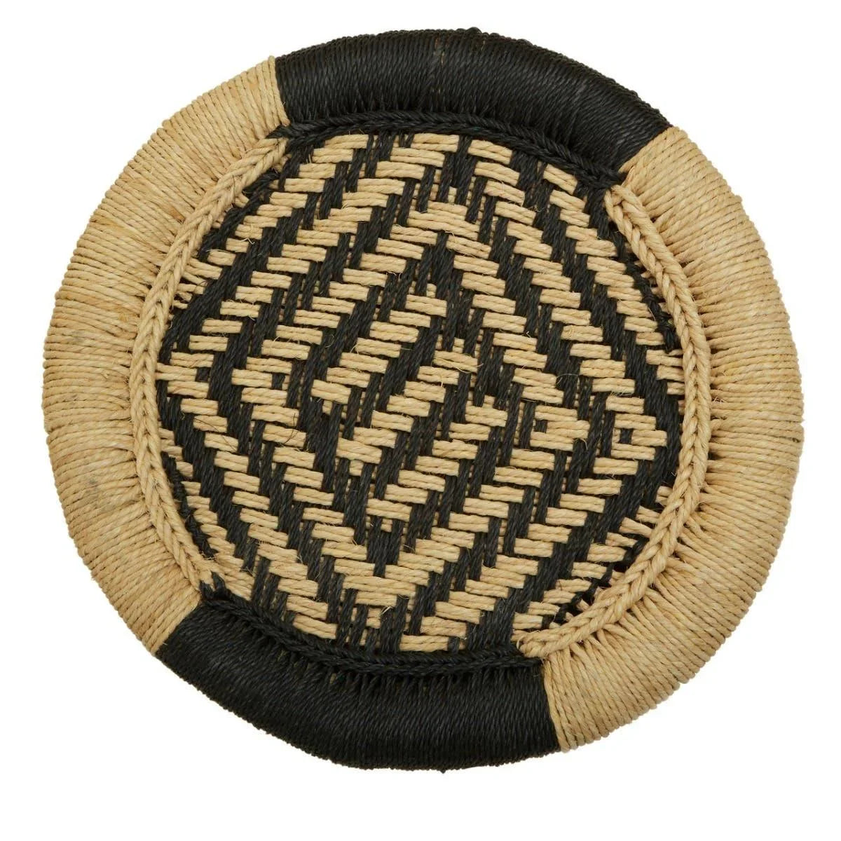 Round woven placemat with black and natural geometric pattern, close up view