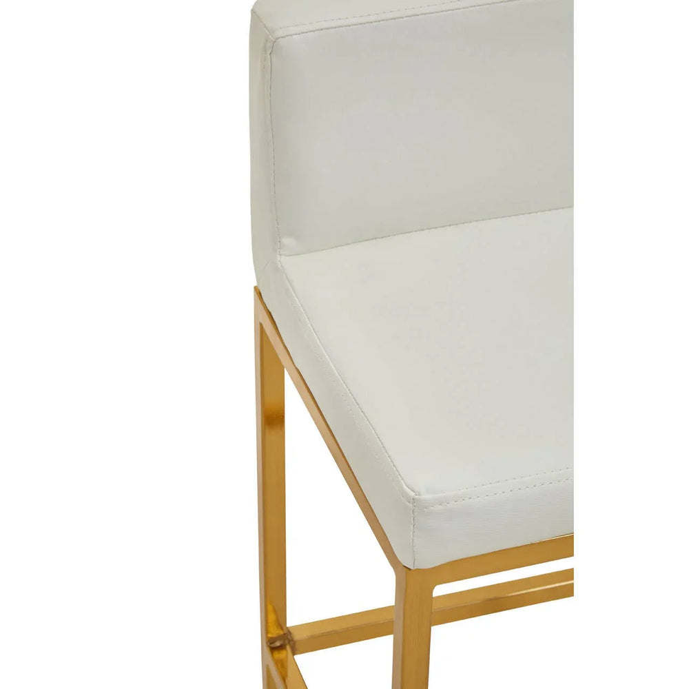 White bar stool with gold metal frame and cushioned seat, close up of corner