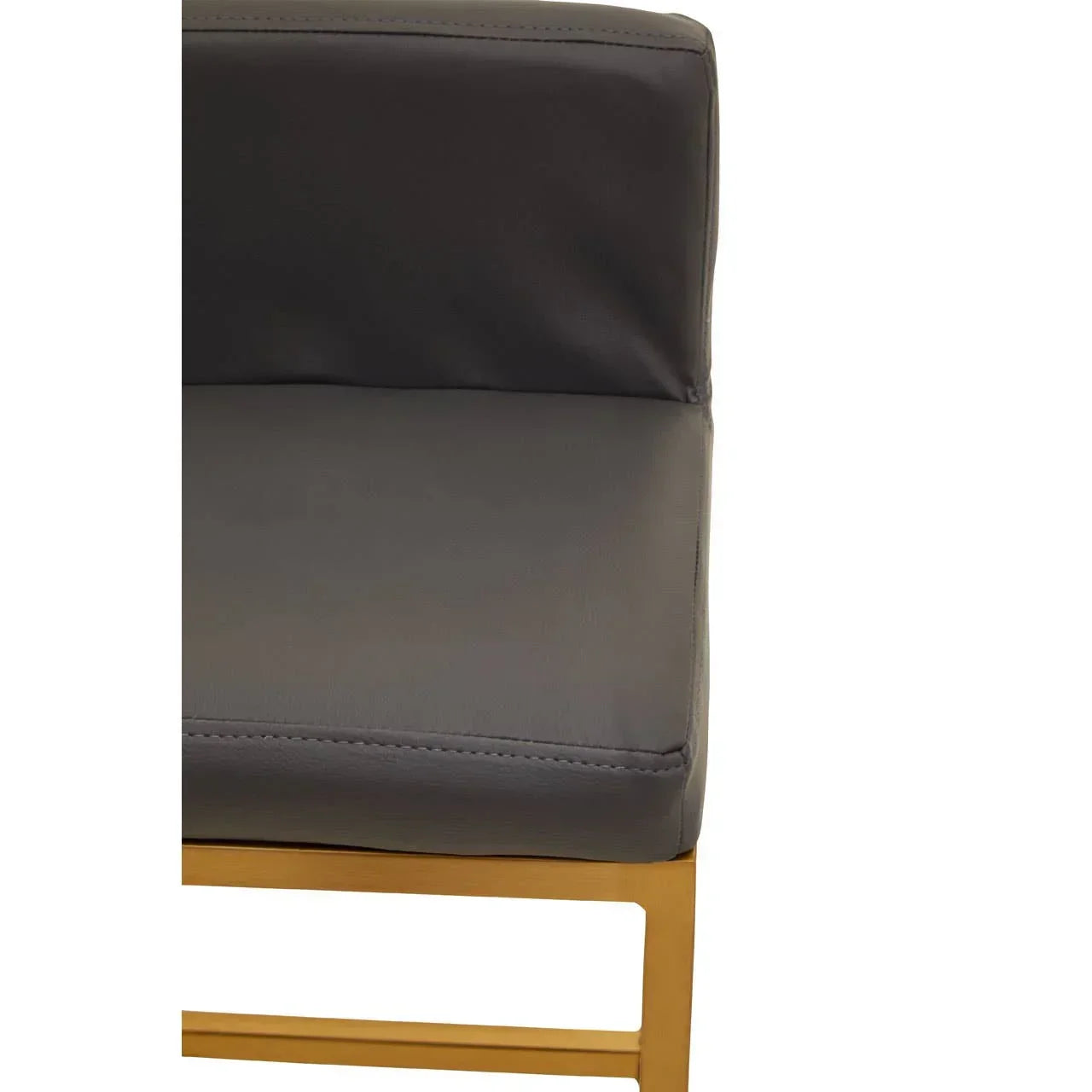 Close view of grey leather dining chair seat with gold metal frame