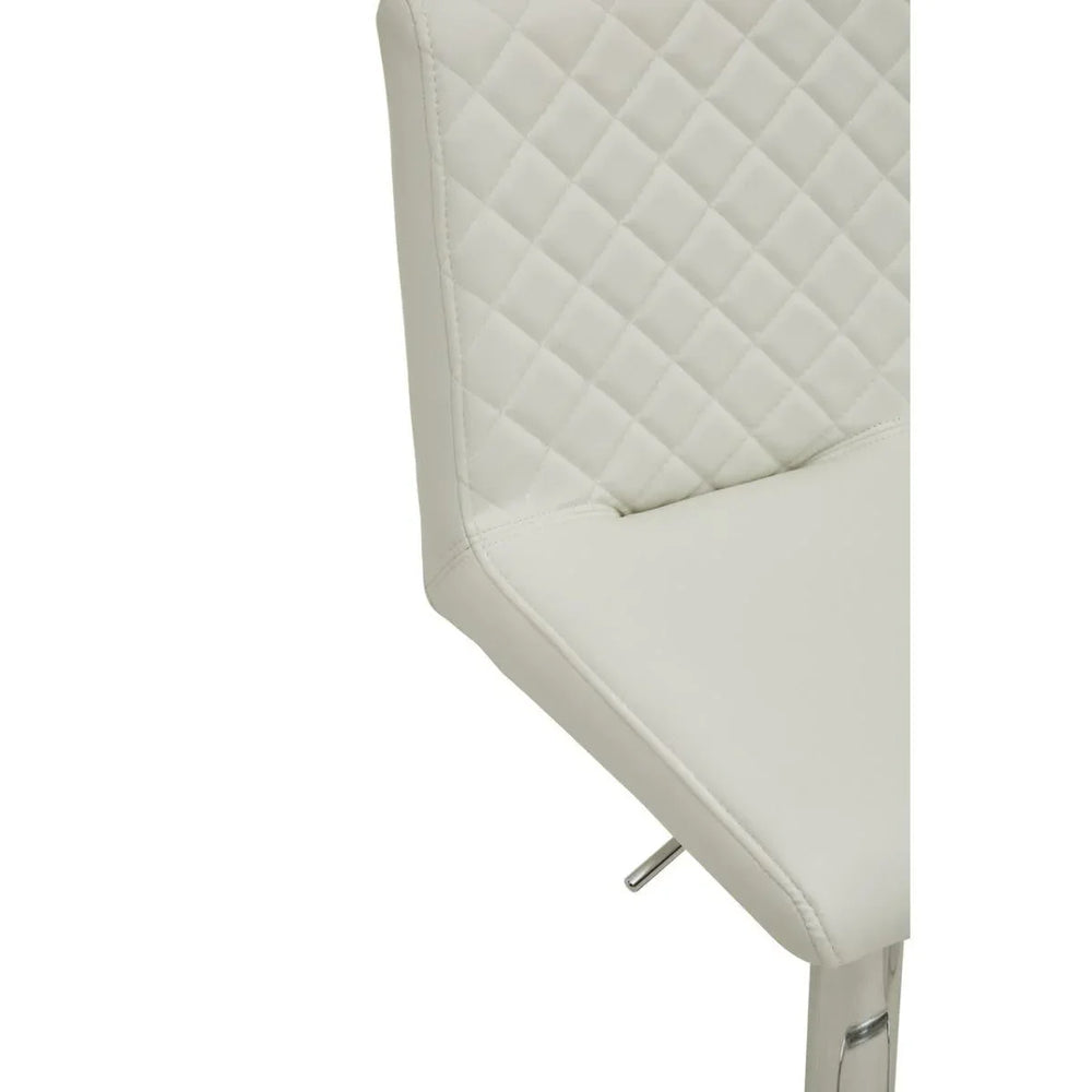 Cream faux leather bar stool with quilted backrest and chrome leg detail close-up