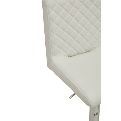 White faux leather dining chair with quilted backrest and chrome legs, close-up view
