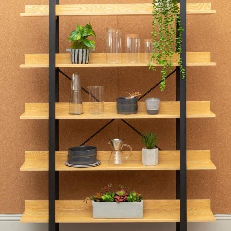 Modern wood and metal shelving unit with plants, vases, and home decor items