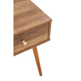 Wooden bedside table with single drawer, gold knob and tapered leg, close-up view