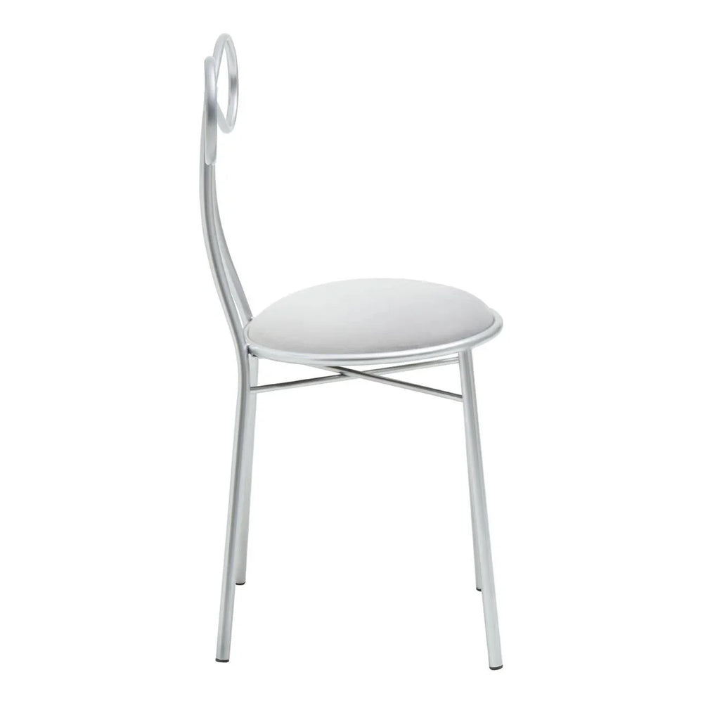 Silver metal dining chair with circular backrest and white padded seat, side view