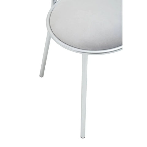 Close-up of silver metal chair leg with round padded seat