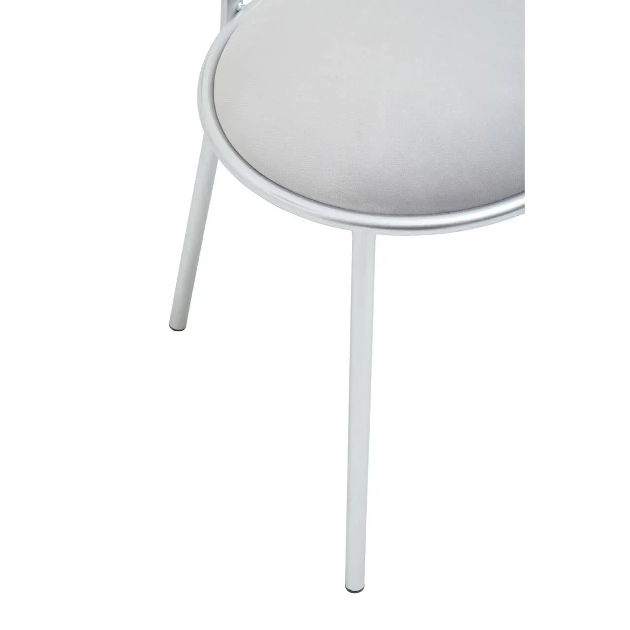 Close-up of silver metal chair leg with round padded seat