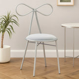 Silver metal accent chair with bow-shaped backrest and cushioned seat in modern room setting