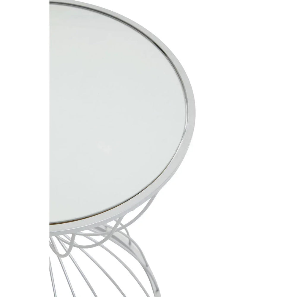Round glass top side table with silver wire metal base, partial top view
