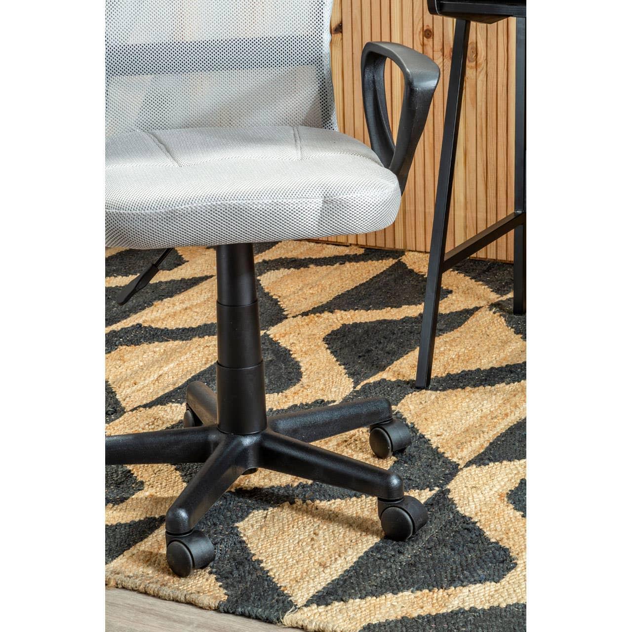 Grey mesh office chair with black plastic armrest and wheeled base on patterned rug