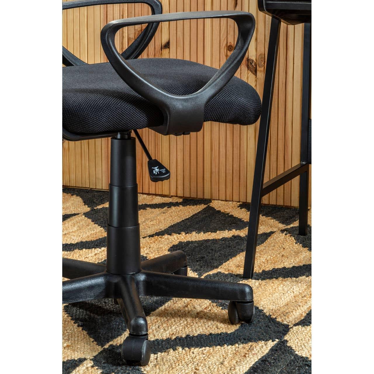 Black mesh office chair with wheels and curved arms on patterned rug