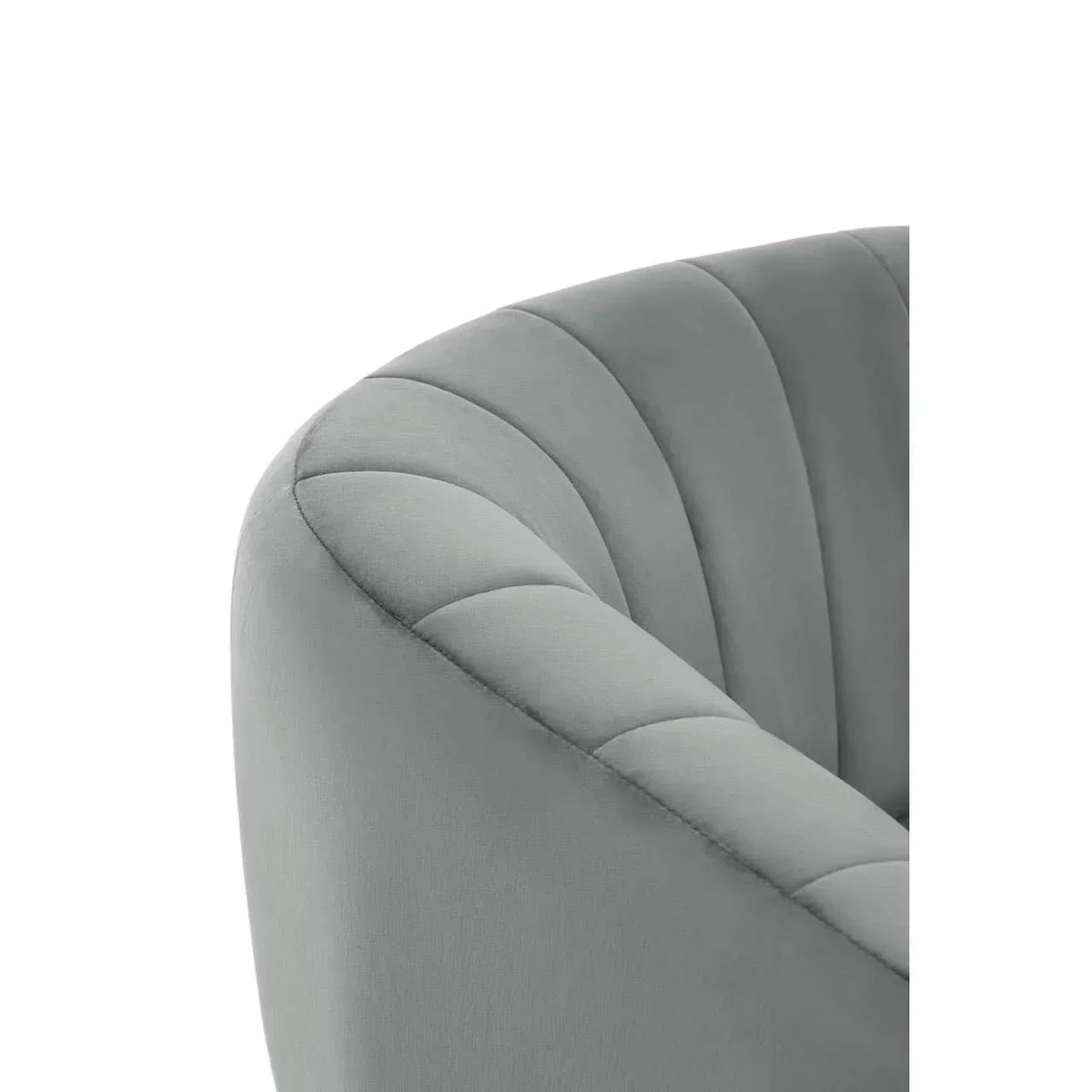 Grey velvet armchair with curved scalloped backrest, close-up of upholstery detail