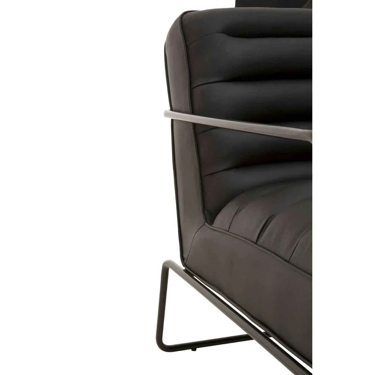 Close-up of black leather armchair with modern metal frame and stitched cushioning